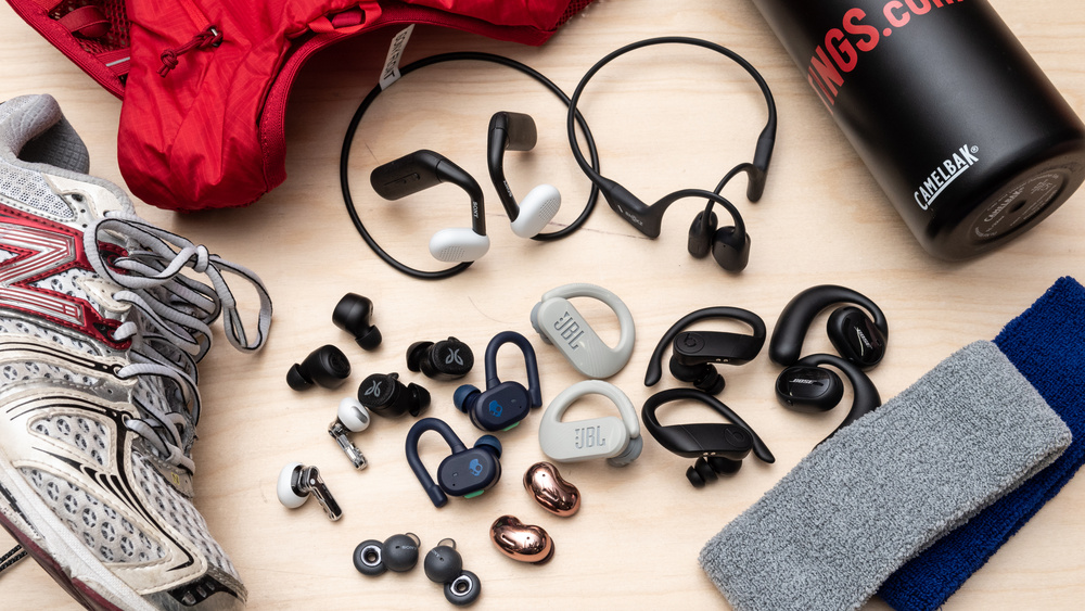 A collection of top wireless earbuds for running placed on a running track